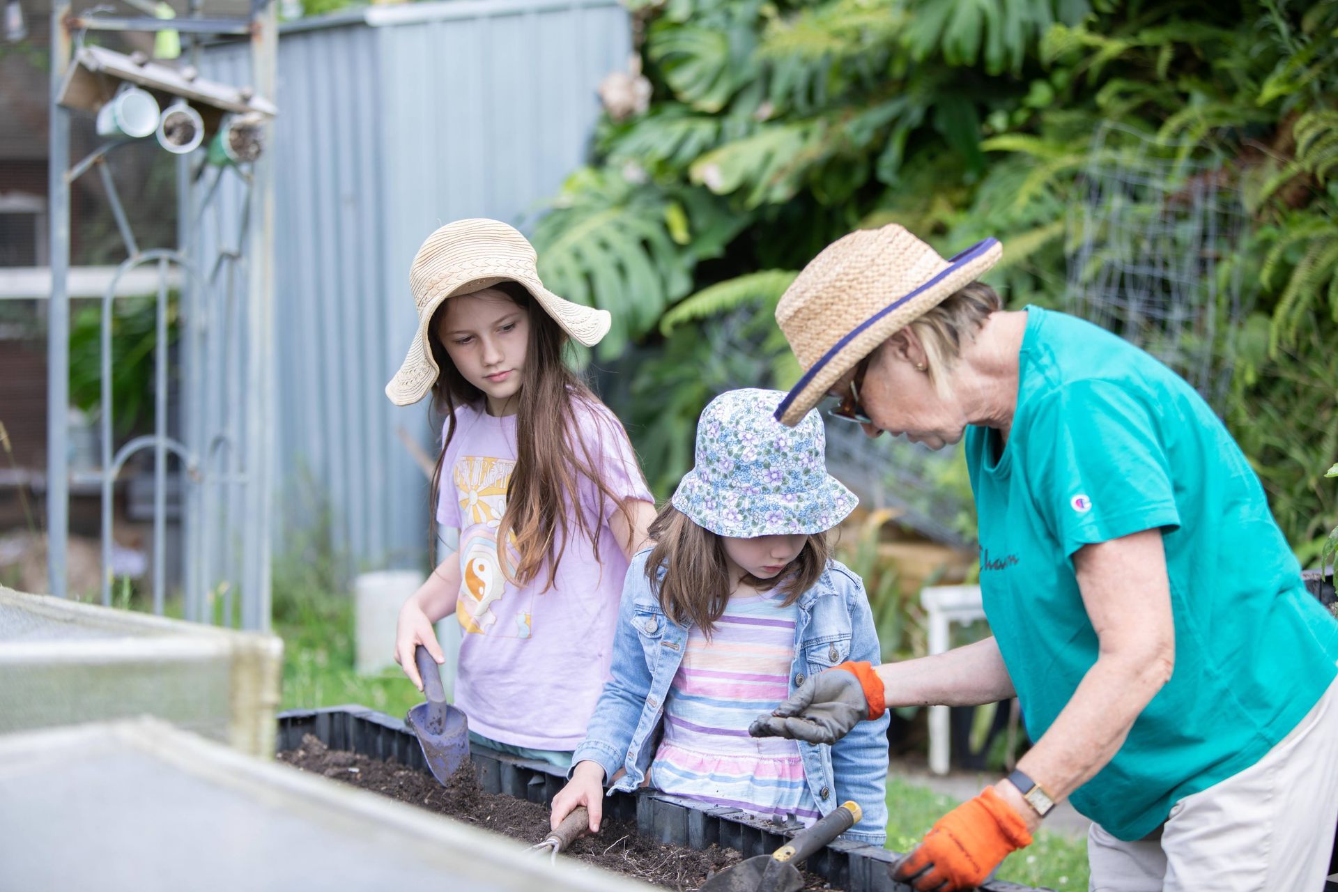 Hands placing vegetable scraps into a compost bin, demonstrating a simple and effective way to reduce food waste.