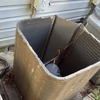 Furnace and water heater in a basement with ductwork.
