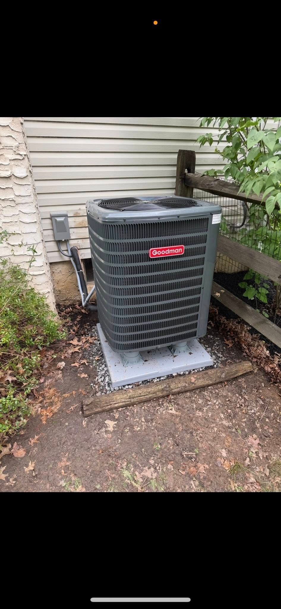 Furnace and water heater in a basement with ductwork.