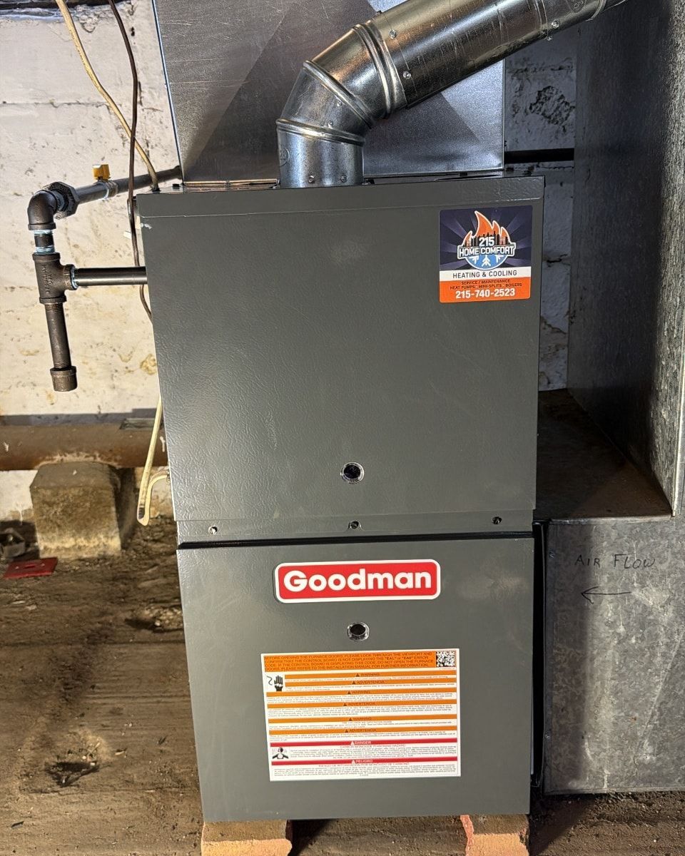 A rectangular hole in a surface is filled with black debris. 