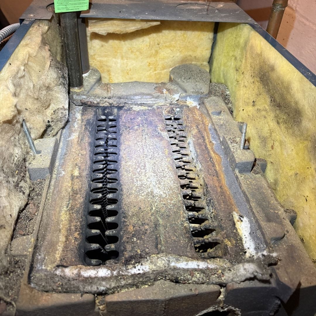Inside of a chimney, showing accumulated gray ash and soot.
