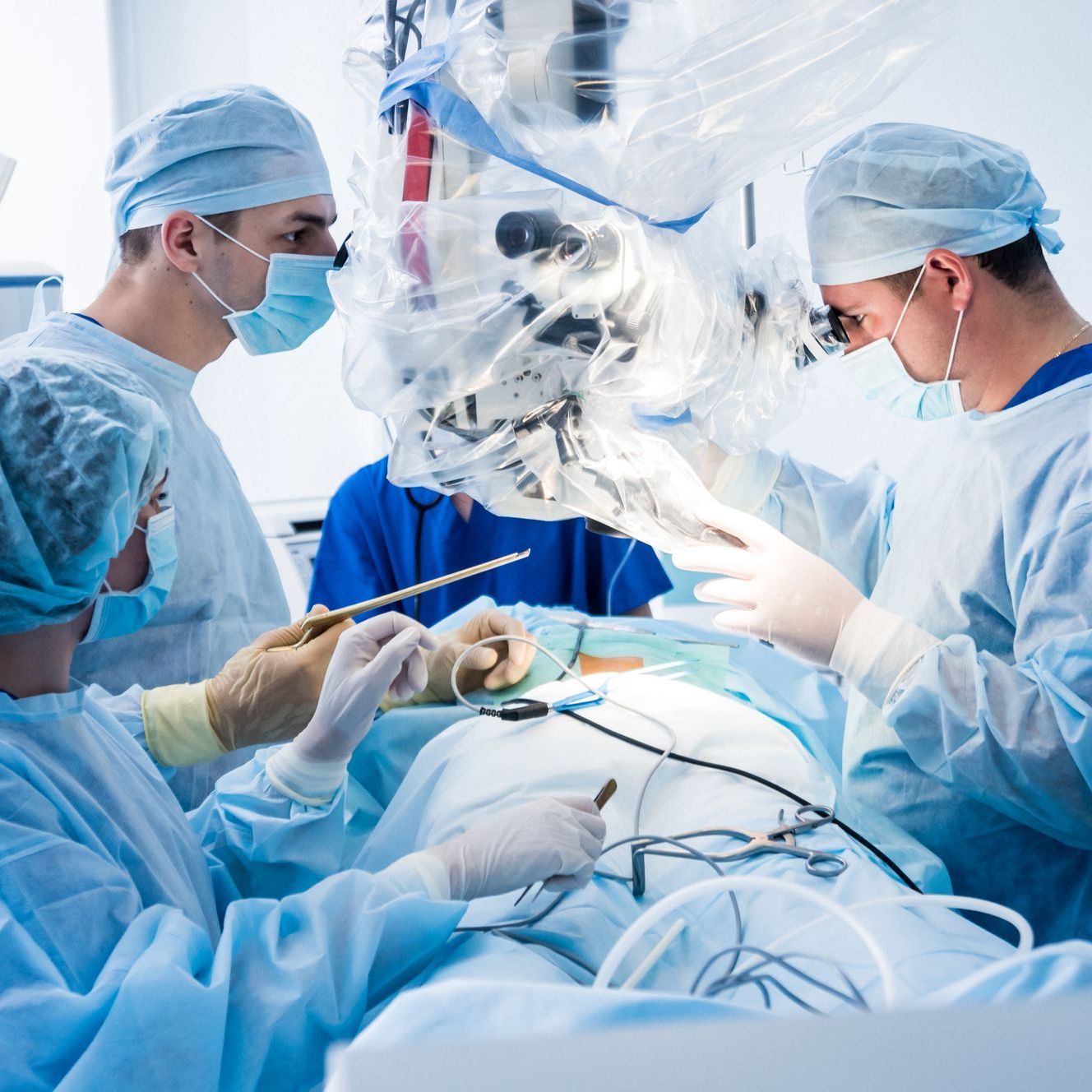 Spinal surgery. Group of surgeons in operating room with surgery equipment. Laminectomy. Modern medical background.