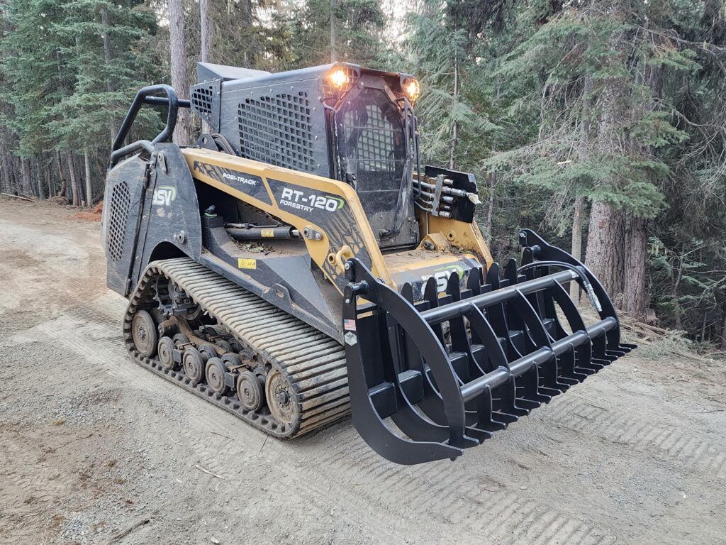 A bulldozer with a large bucket is parked on a dirt road.