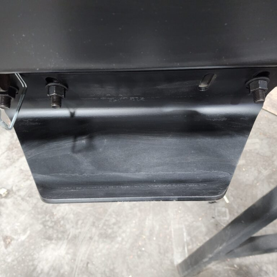 A black box is sitting on top of a concrete floor.