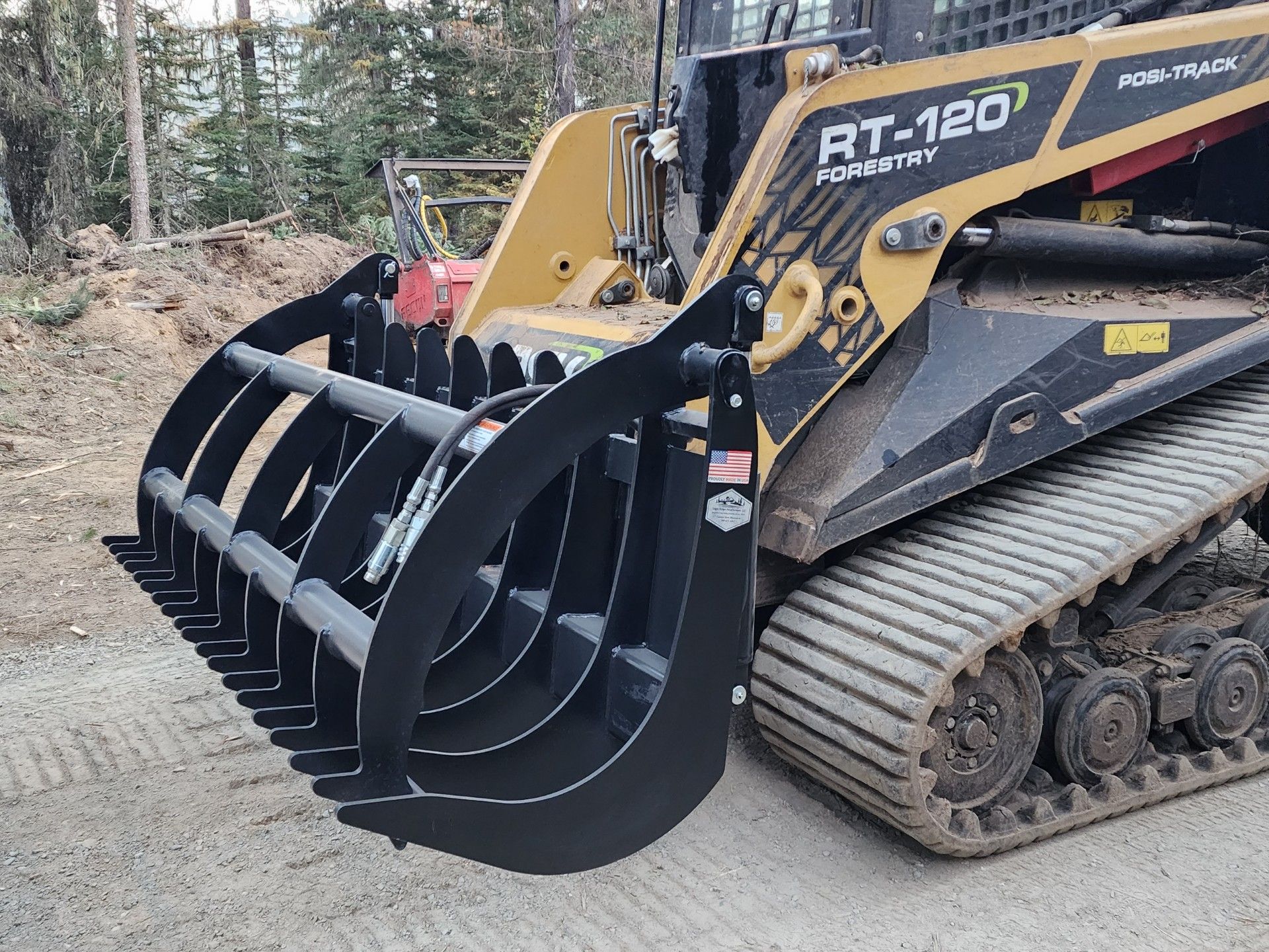 A bulldozer with a grapple bucket attached to it.