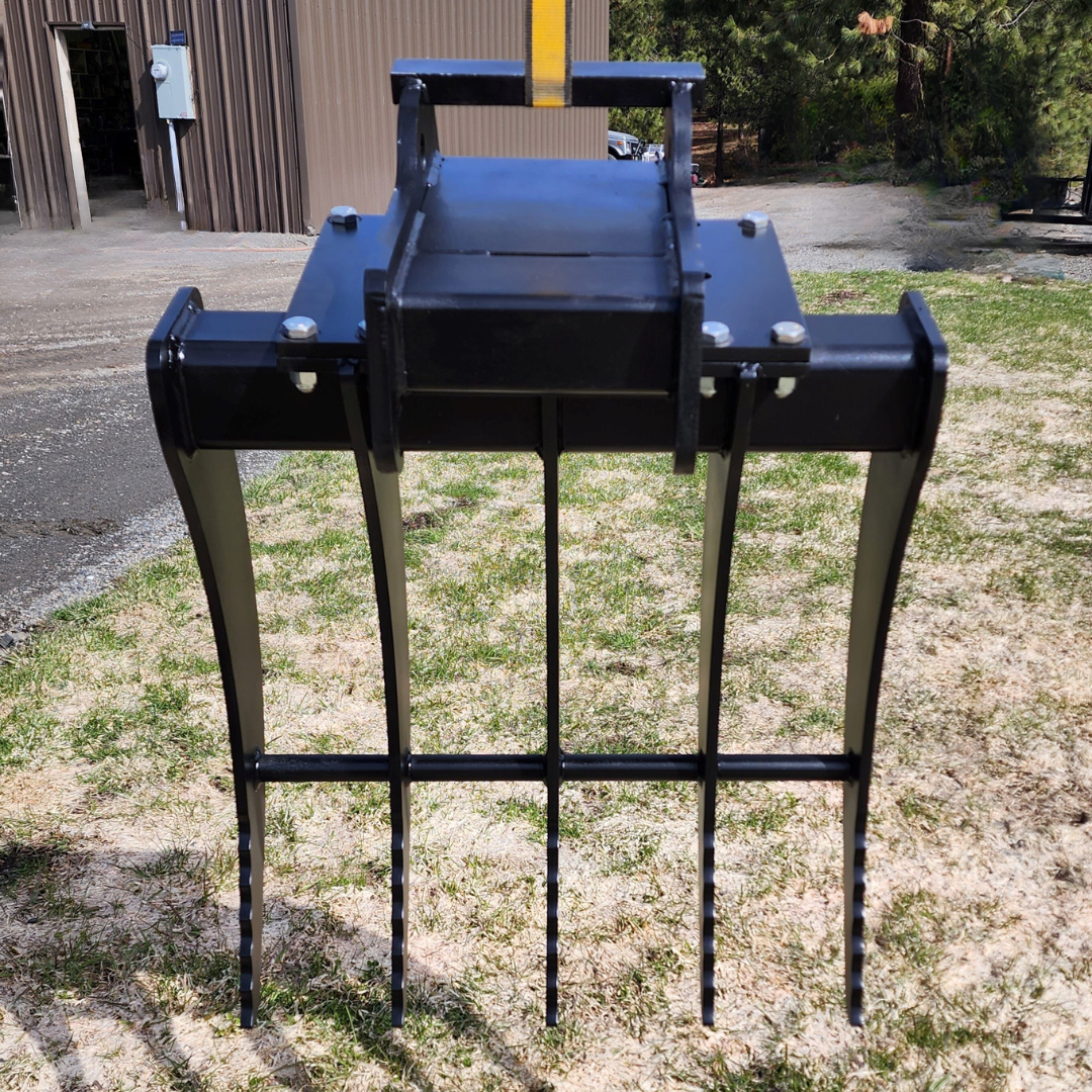 A black fork is sitting in the grass in front of a building.