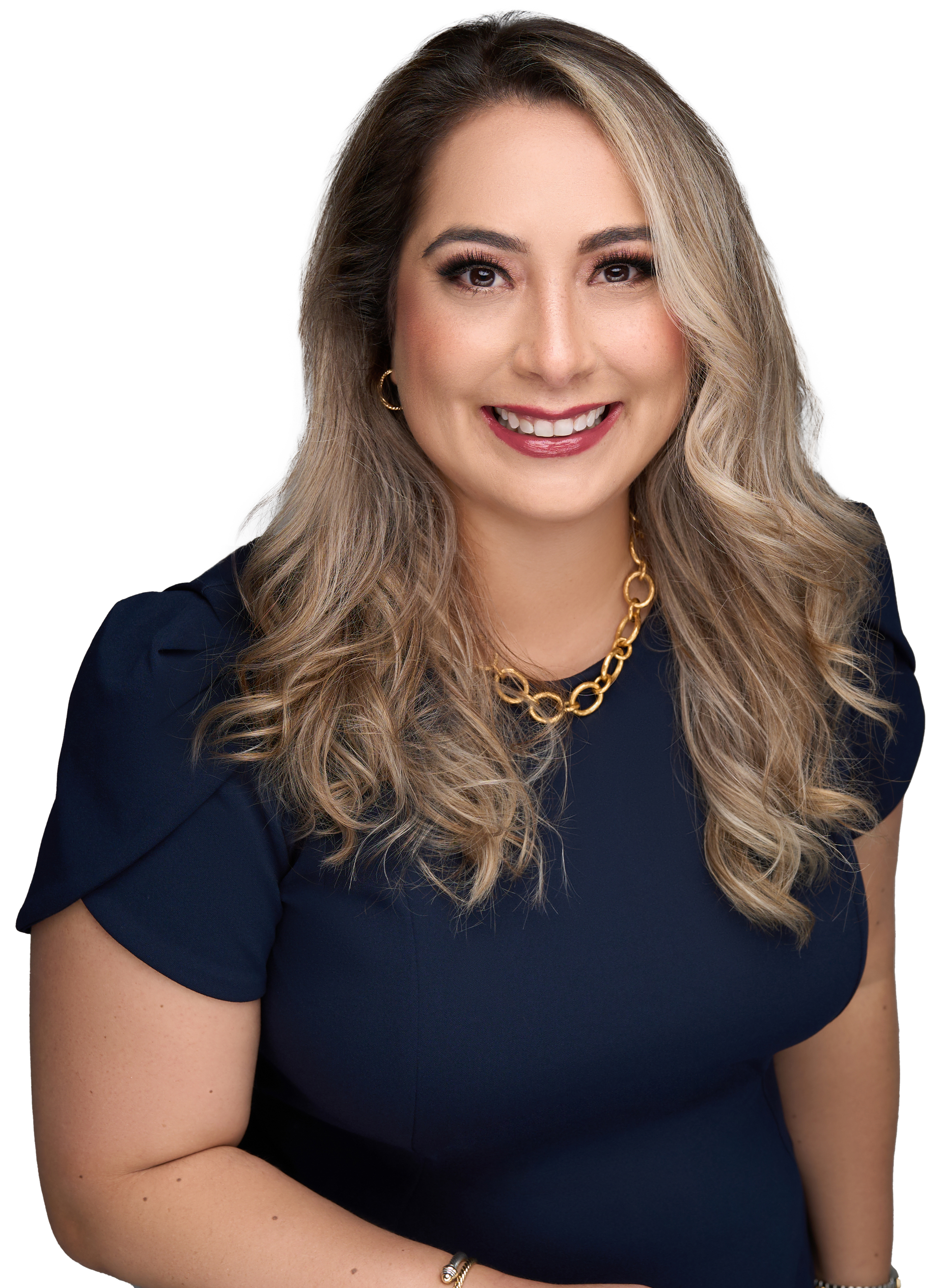 A woman in a blue shirt and gold necklace is smiling for the camera.