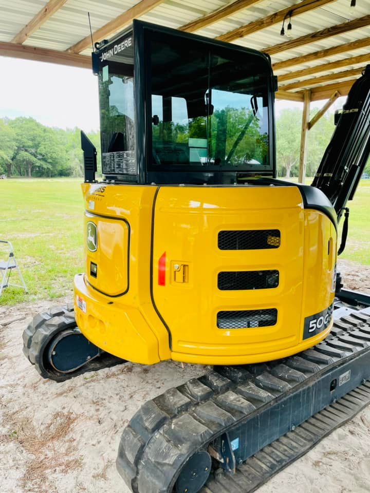 Yellow John Deere 50G excavator on tracks.