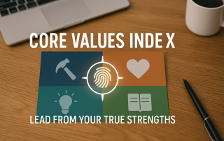 Core Values Index graphic on a wooden desk with a laptop, mug, and pen. The graphic has a fingerprint in the center and is surrounded by four colored boxes with symbols.