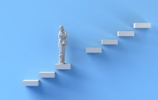 Figure of a person standing on a staircase, contemplating; blue background.