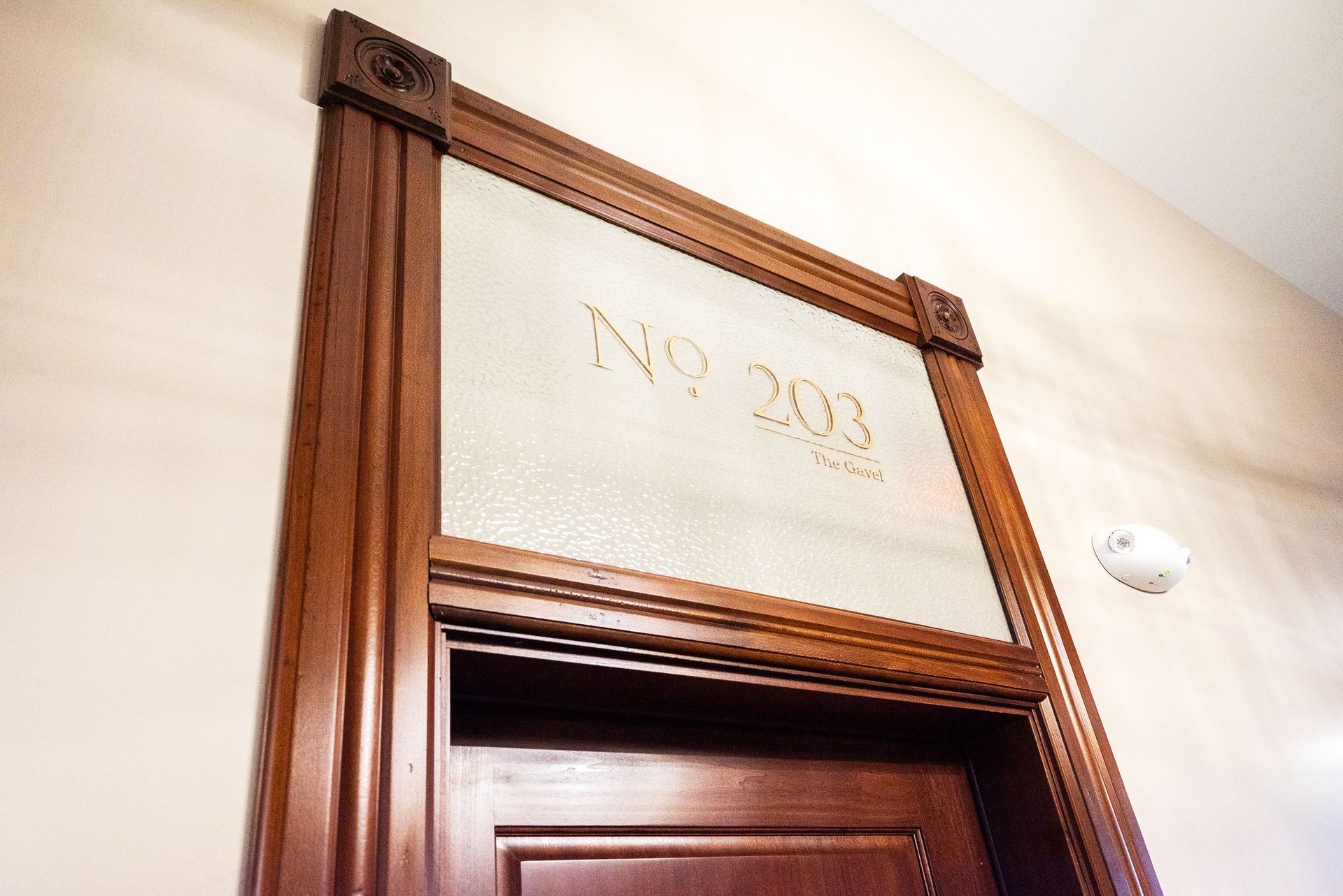 Wooden door frame with frosted glass, displaying 