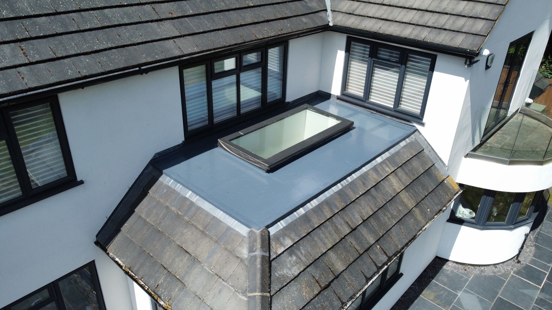 view of the back of a house with flat roof