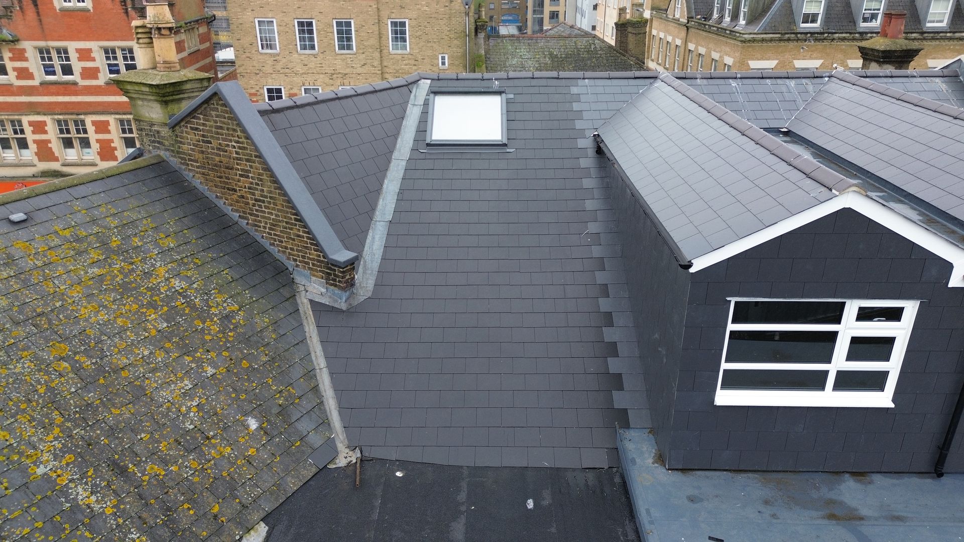 an aerial view of a roof with a window and a skylight .