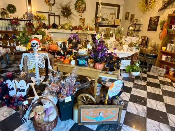 A store filled with lots of halloween decorations including a skeleton