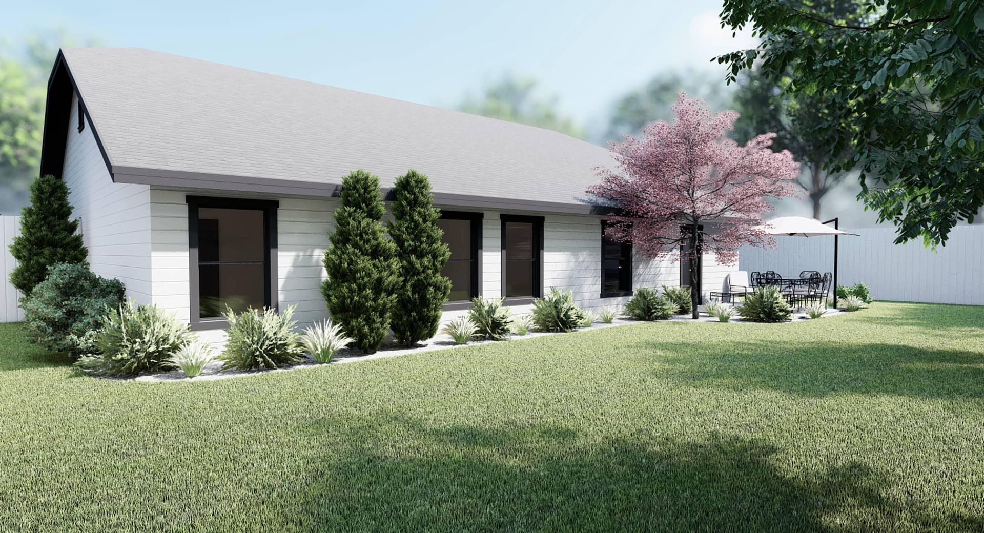 A white house with a gray roof is sitting on top of a lush green lawn.