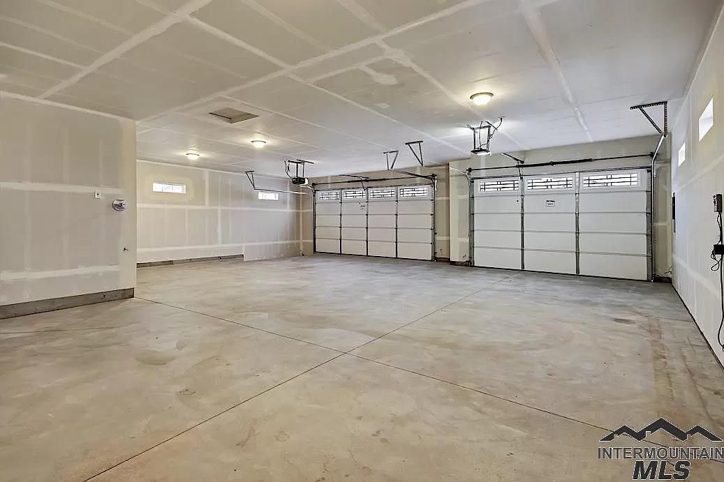 A large empty garage with a lot of garage doors.