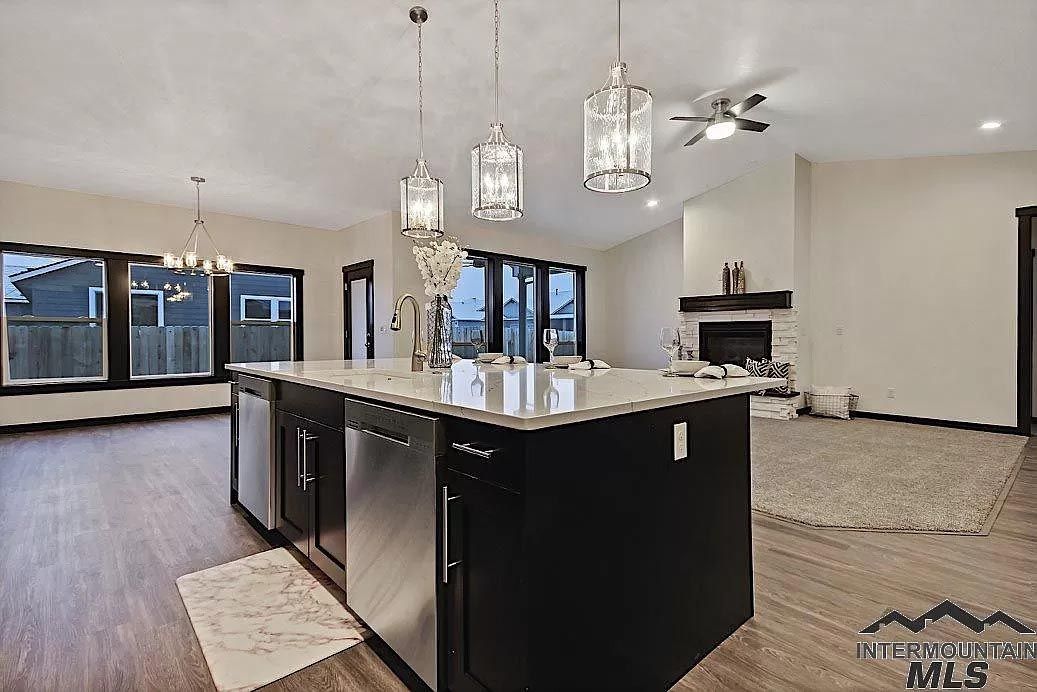 A kitchen with a large island and stainless steel appliances.