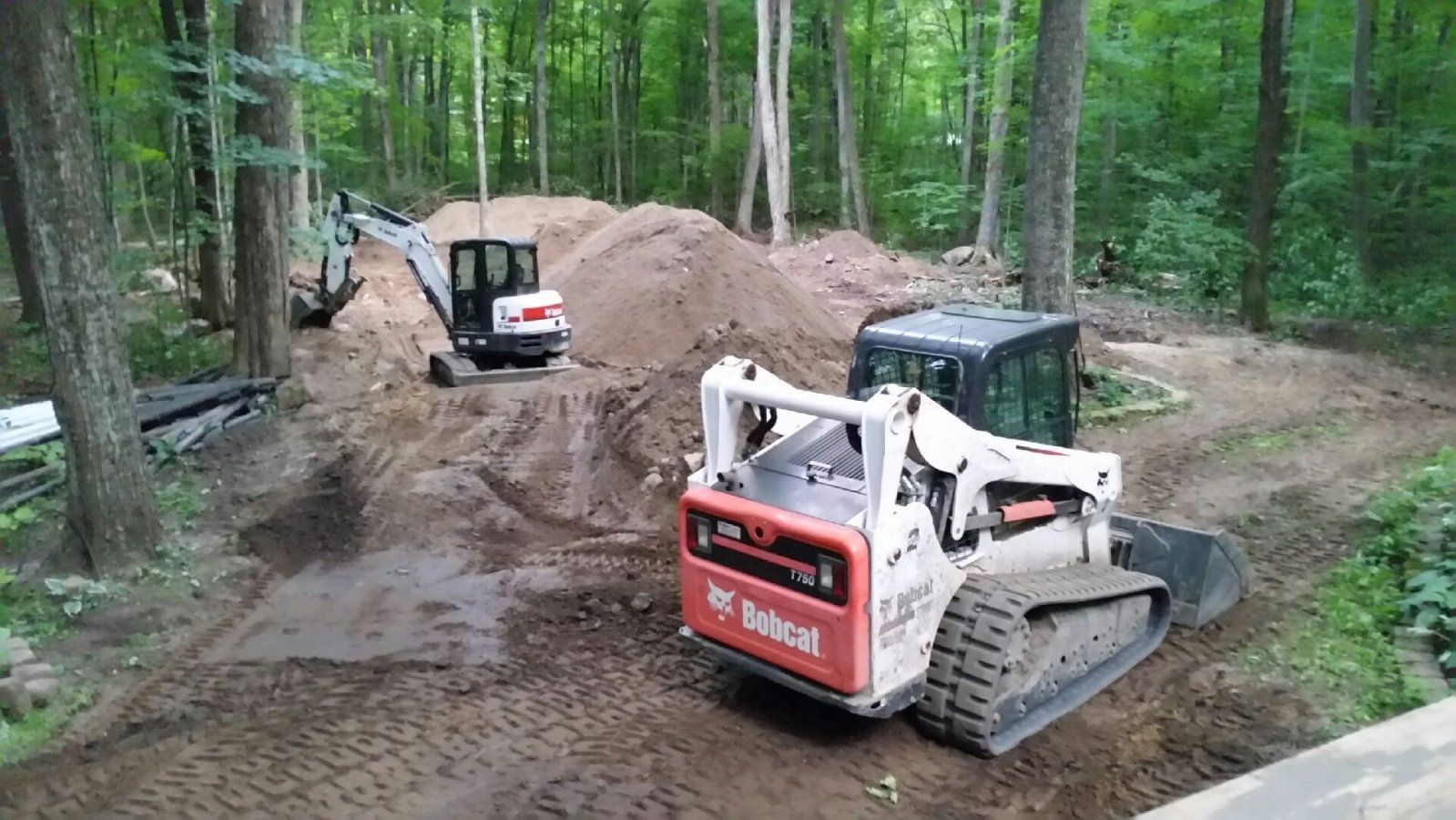 skid steer and hydraulic shovel excavating