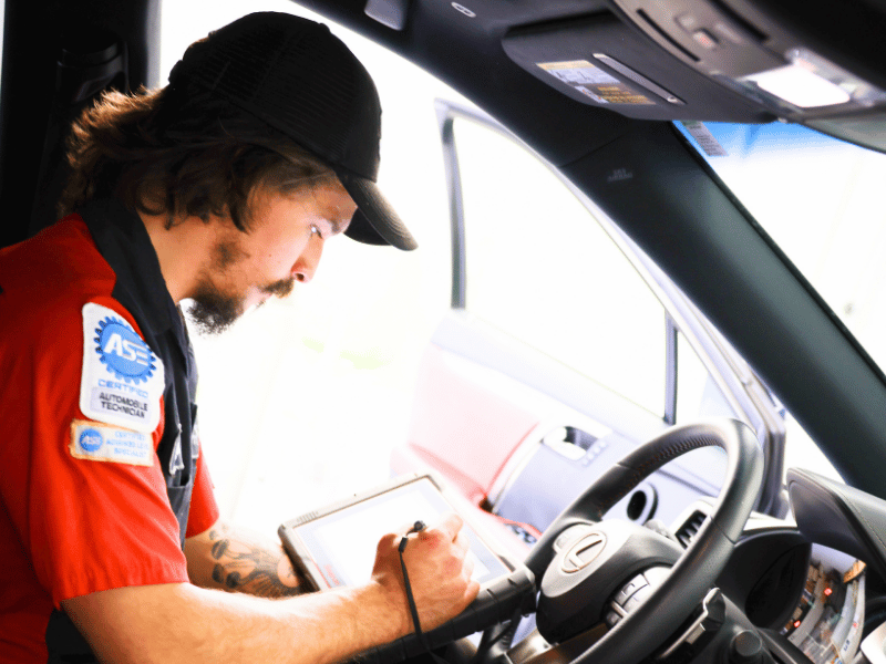 Rhys with a tablet, working inside a vehicle.