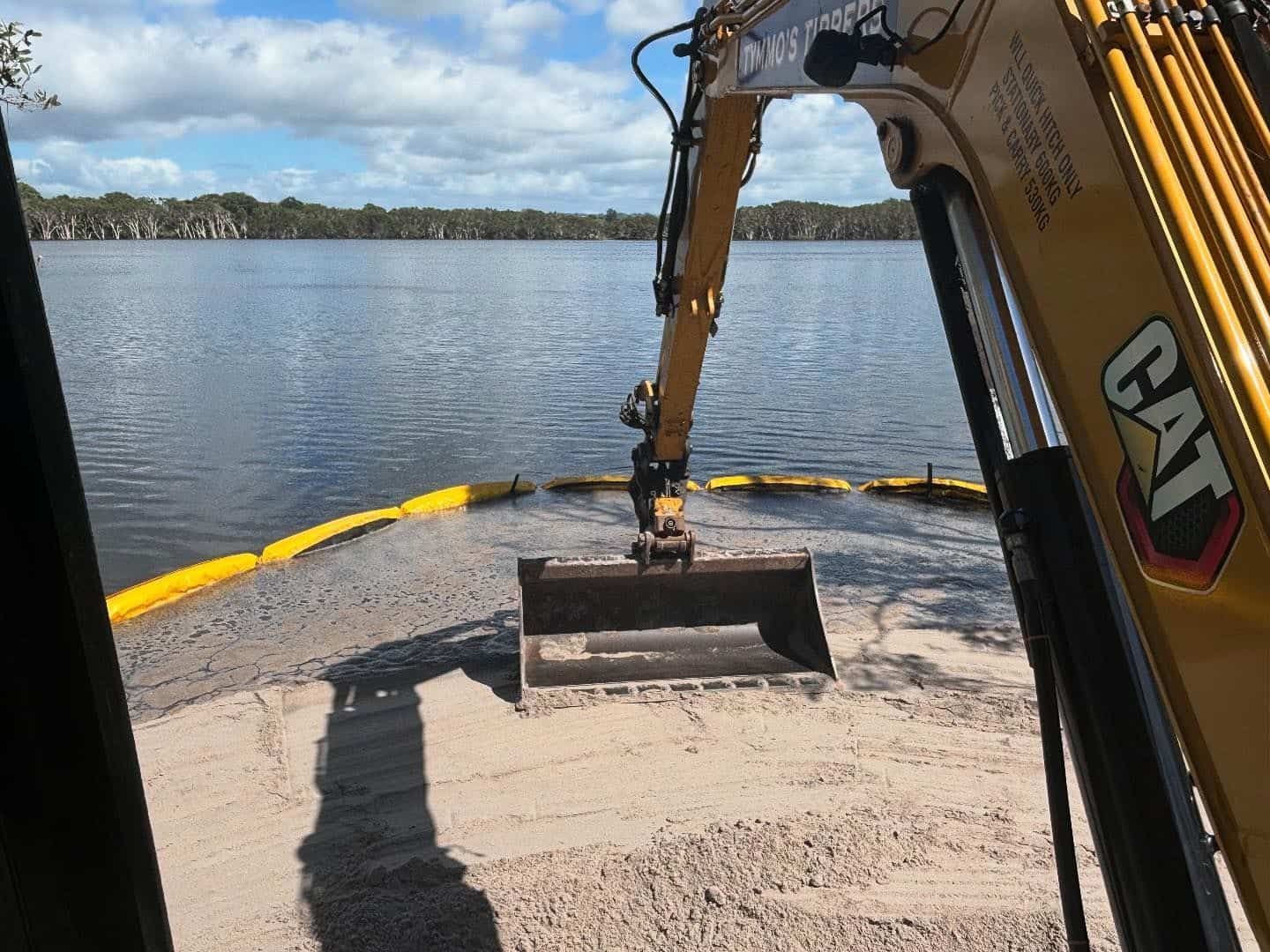 A Cat Excavator Is Working On A Beach Near A Lake — Tymmo's Tippers In Lismore, NSW