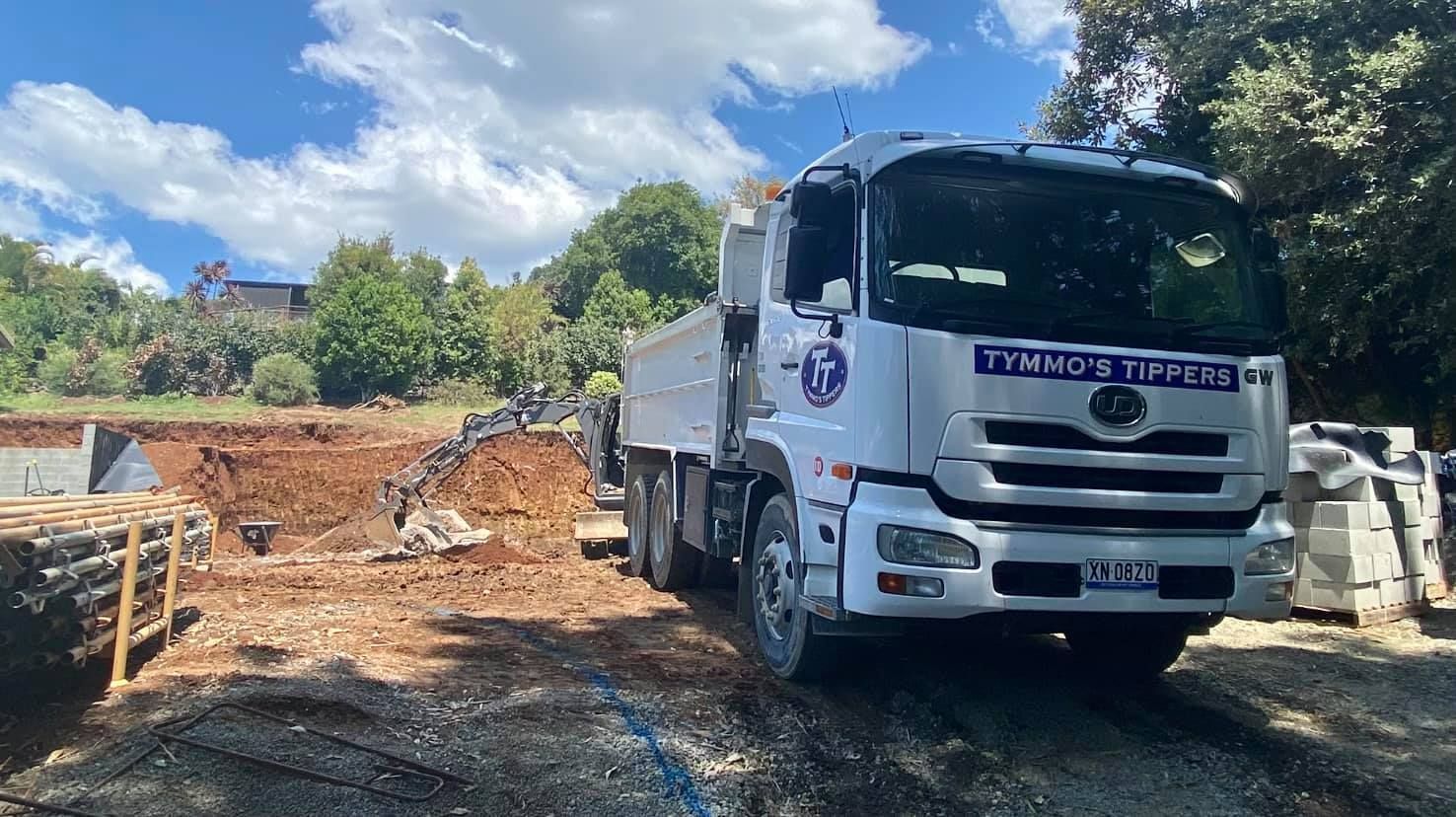 A White Dump Truck Is Parked In A Dirt Lot — Tymmo's Tippers In Byron Bay, NSW