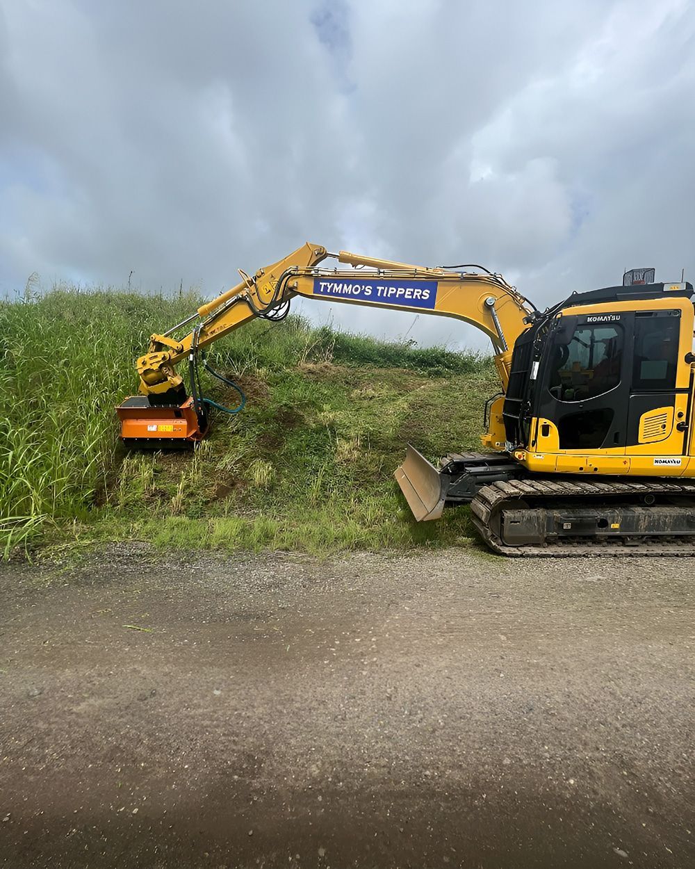 A Yellow Excavator With A Flail Mower Attachment — Tymmo's Tippers In Lismore, NSW