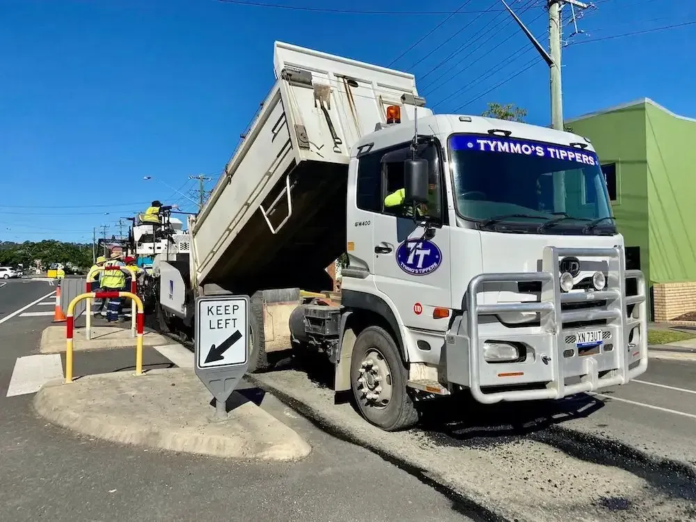 A Dump Truck Is Parked On The Side Of The Road Next To A Keep Left Sign — Tymmo's Tippers In Kingscliff, NSW