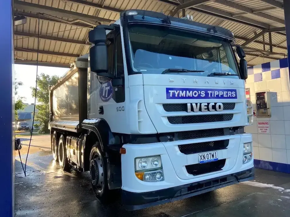 A White Iveco Truck Is Parked In A Car Wash — Tymmo's Tippers In Ballina, NSW