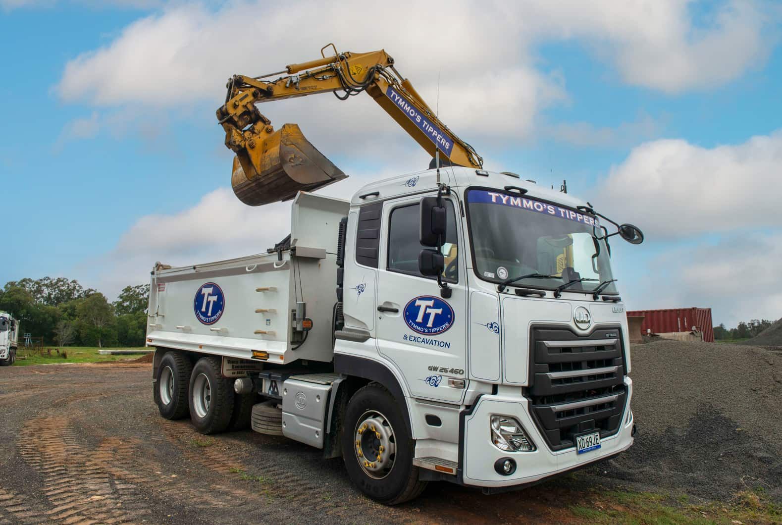 A Dump Truck With A Crane Attached To It Is Parked In A Gravel Lot — Tymmo's Tippers In Alstonville, NSW