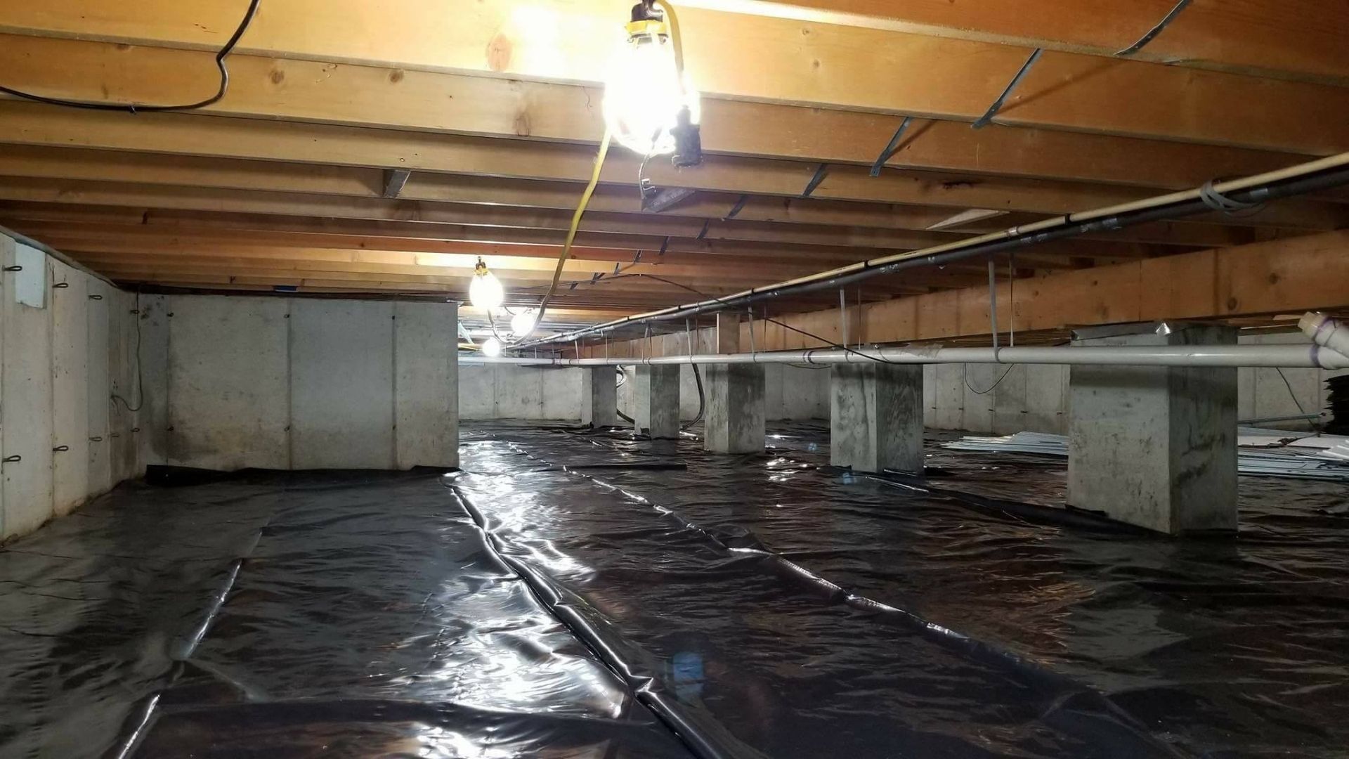 A crawl space with a vapor barrier installed in Chesapeake, VA