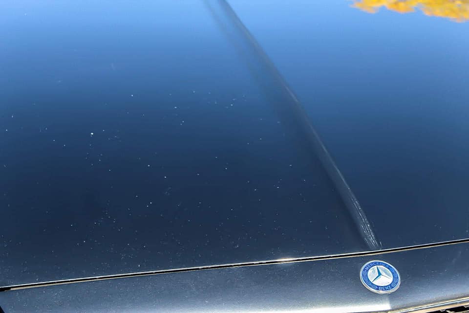 a close up of the before and after hood of a mercedes benz car with rock chips .
