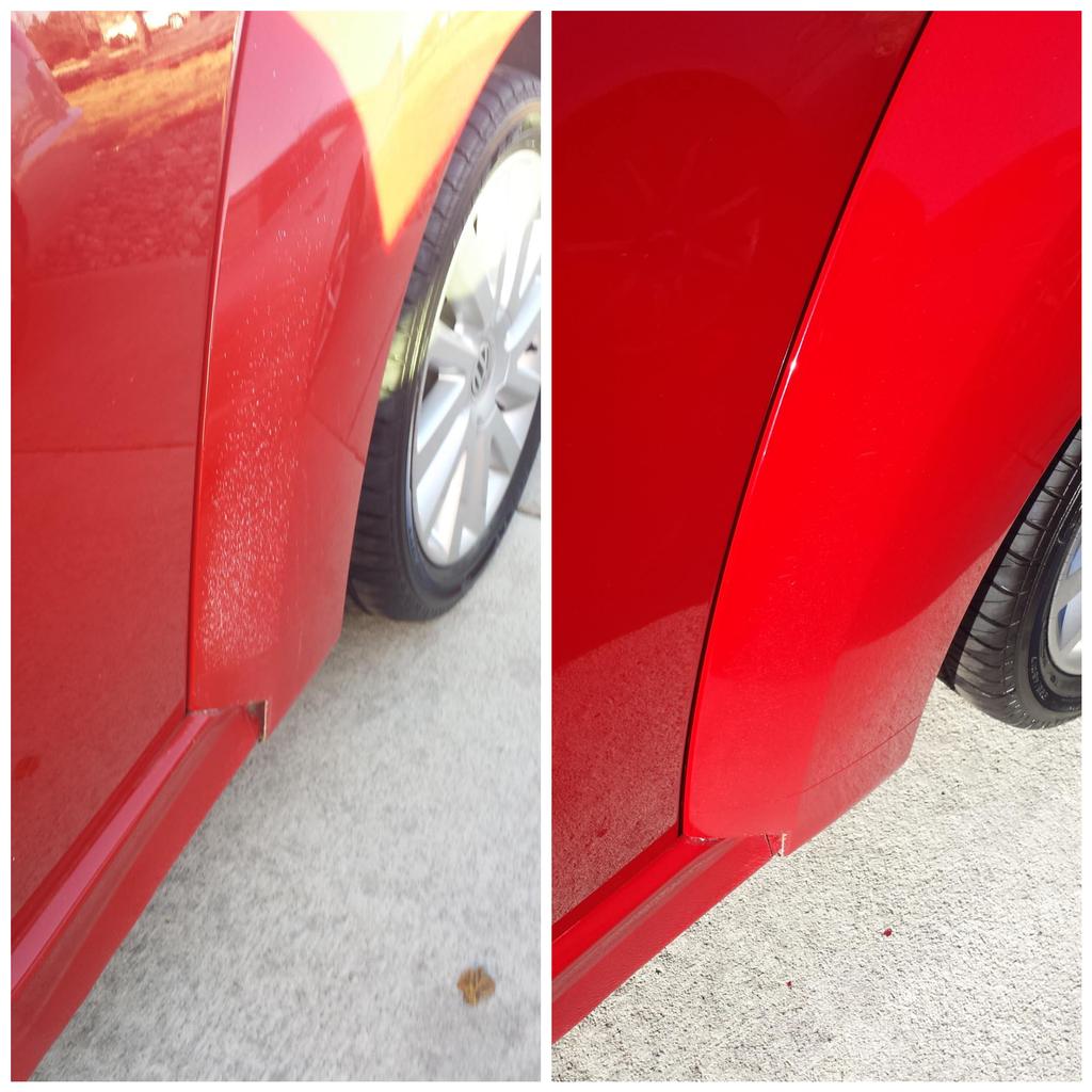 a red car with a rock chips on the side of wheel well .