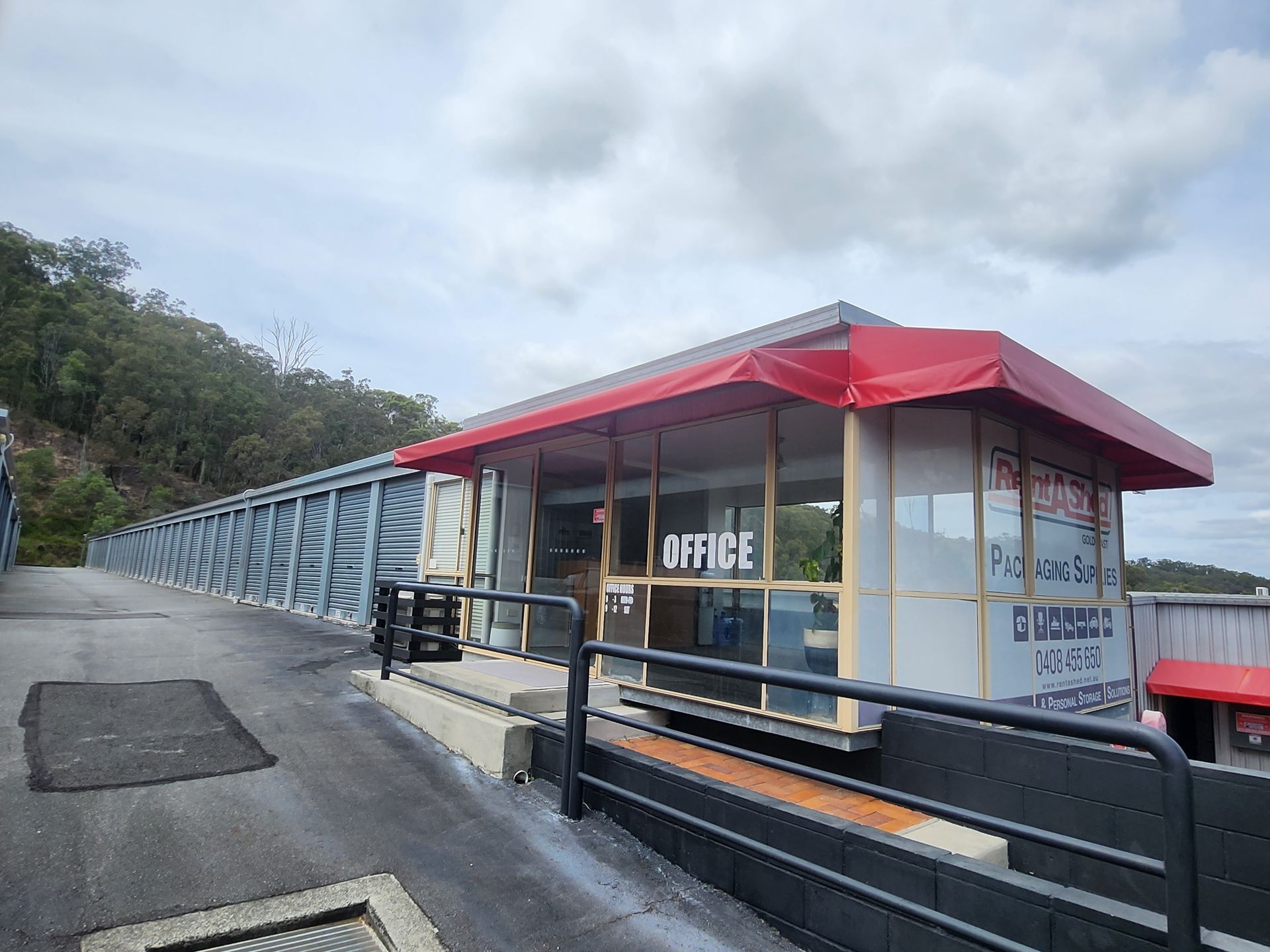 A storage unit filled with boxes and a bicycle.