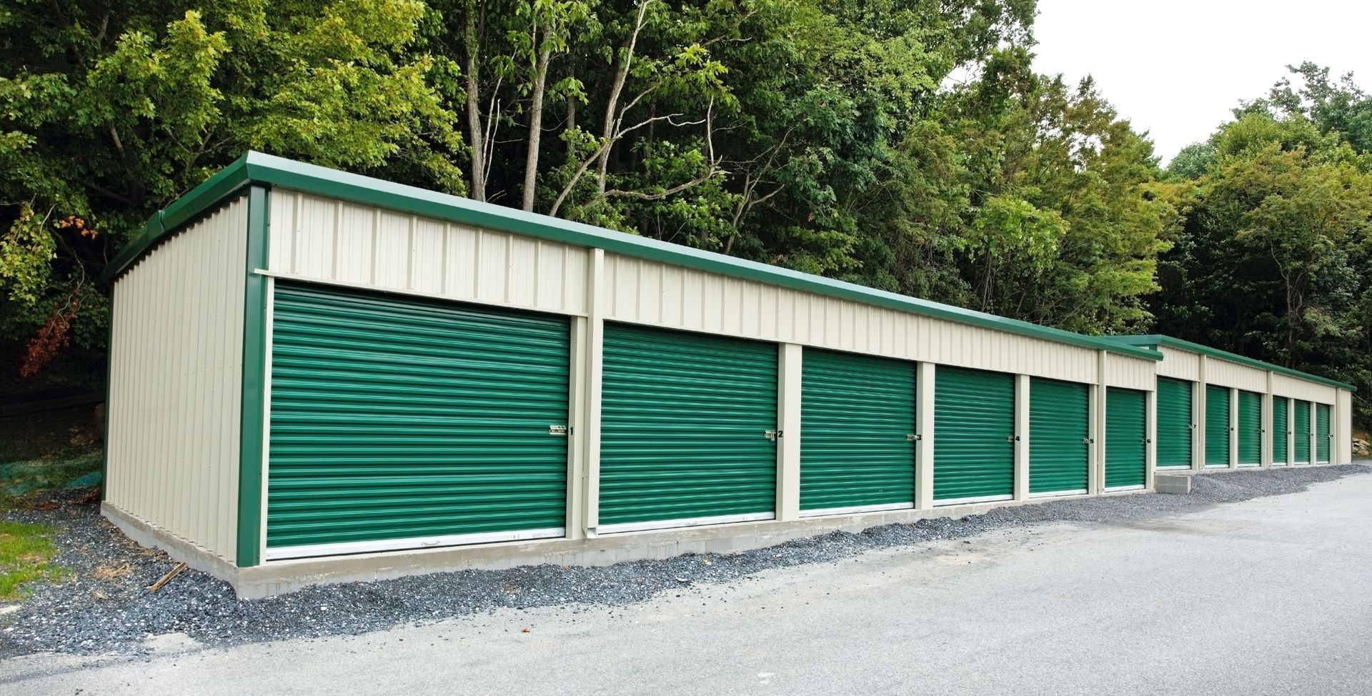 A row of storage units with green doors