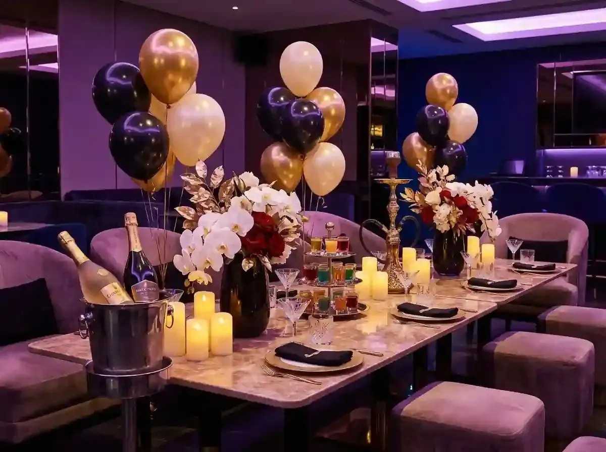 Elegant candlelit dinner table with floral arrangements, wine glasses, and plated dishes