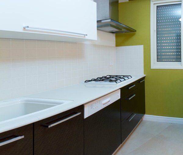 modern kitchen cabinets in a clean kitchen with a range and a range hood