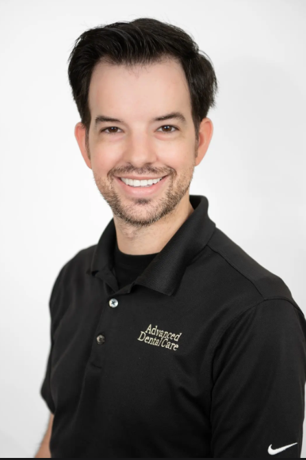 A man in a black shirt is smiling. A man in a black shirt is smiling.