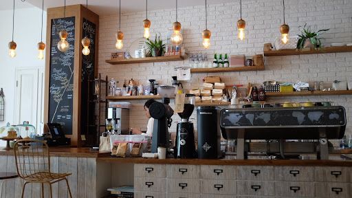 Barista behind a coffee bar in a cafe