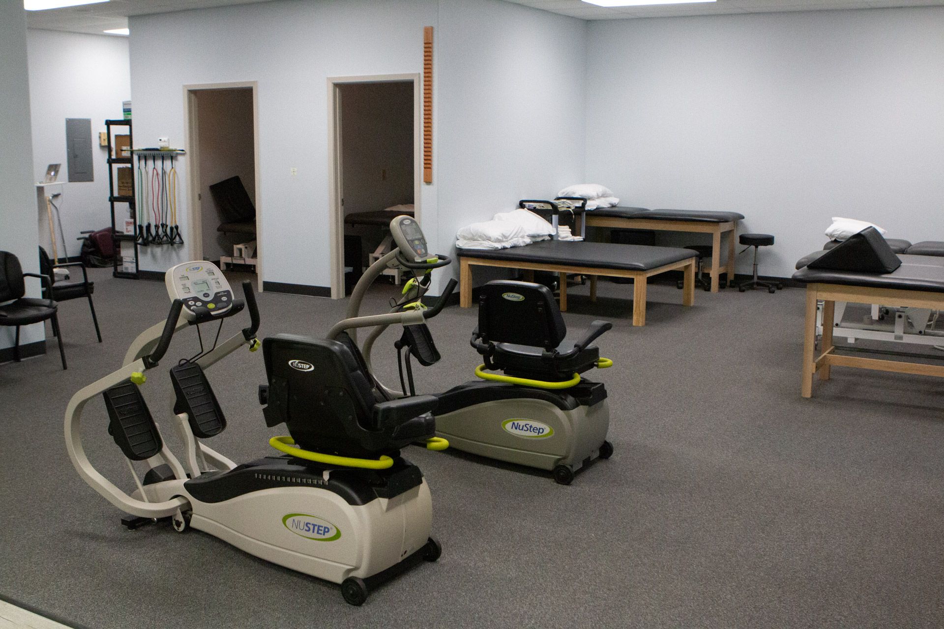 Two exercise bikes are sitting in a room next to each other.