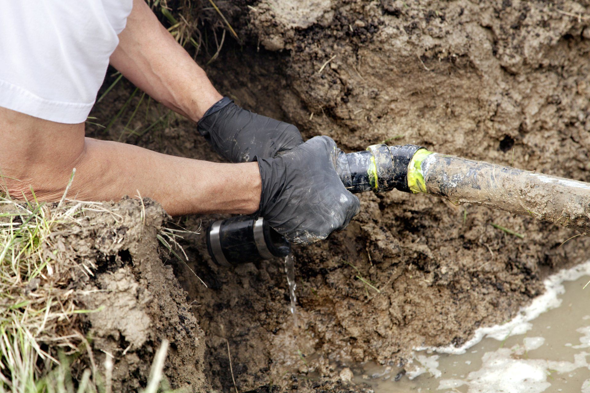 Septic Installation — Man Installing A Septic Tank in Barnstable, MA