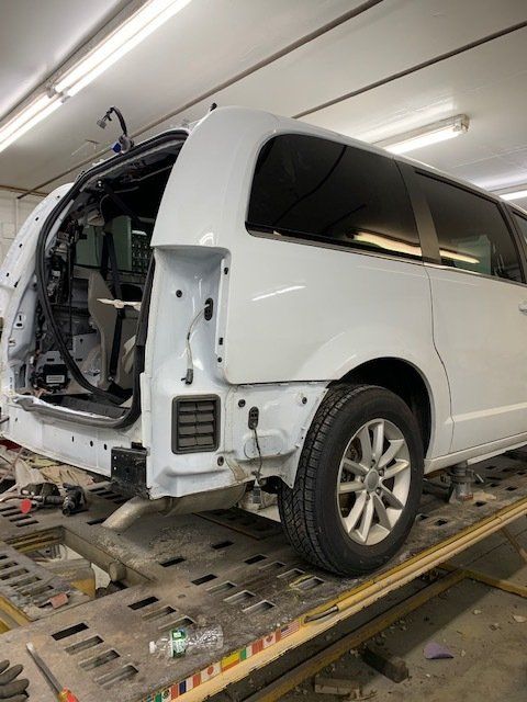 Vehicle At The Top Of A Lift — Villas, NJ — John's Auto Body