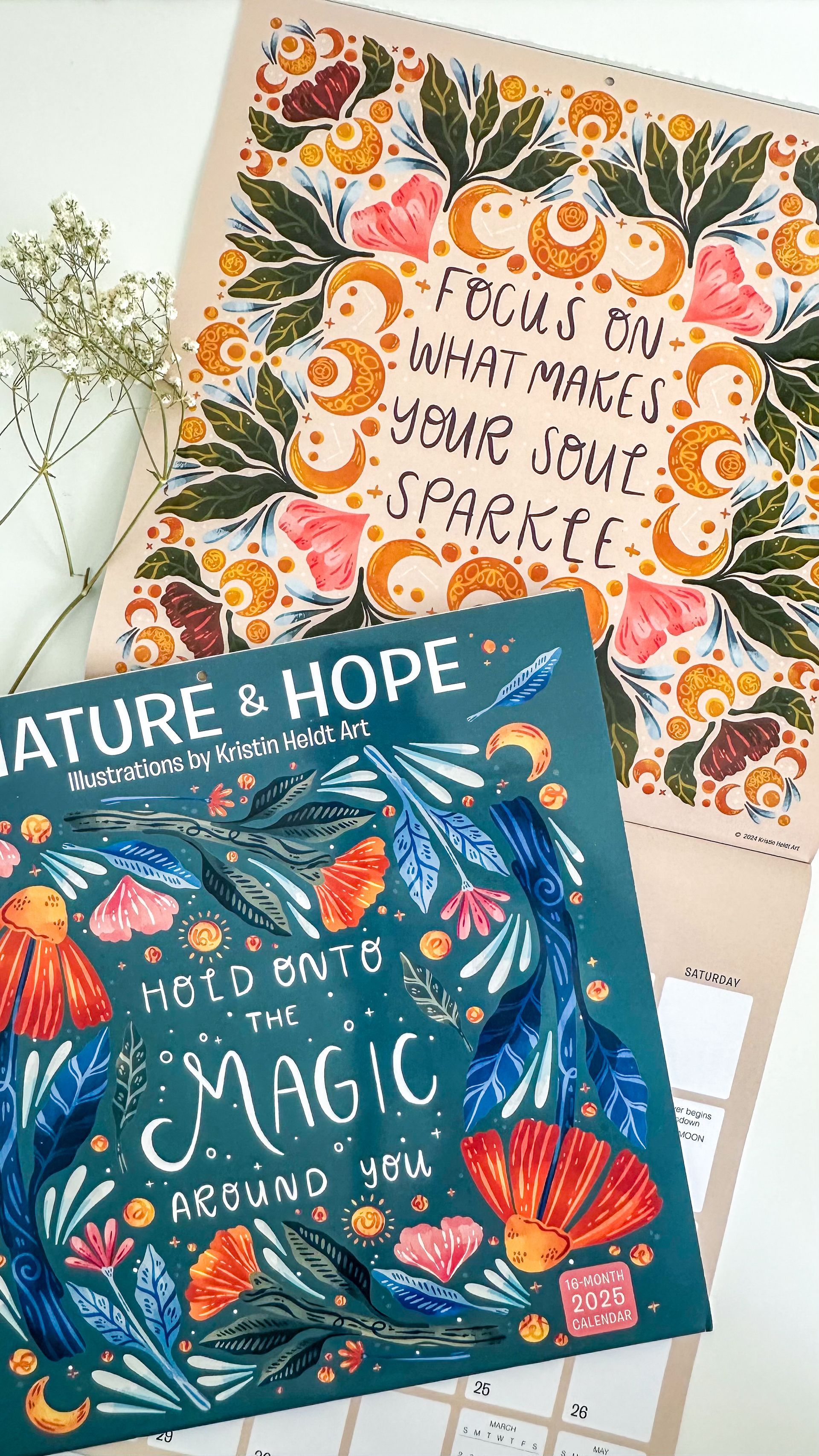 A calendar with a floral design and a quote on it.