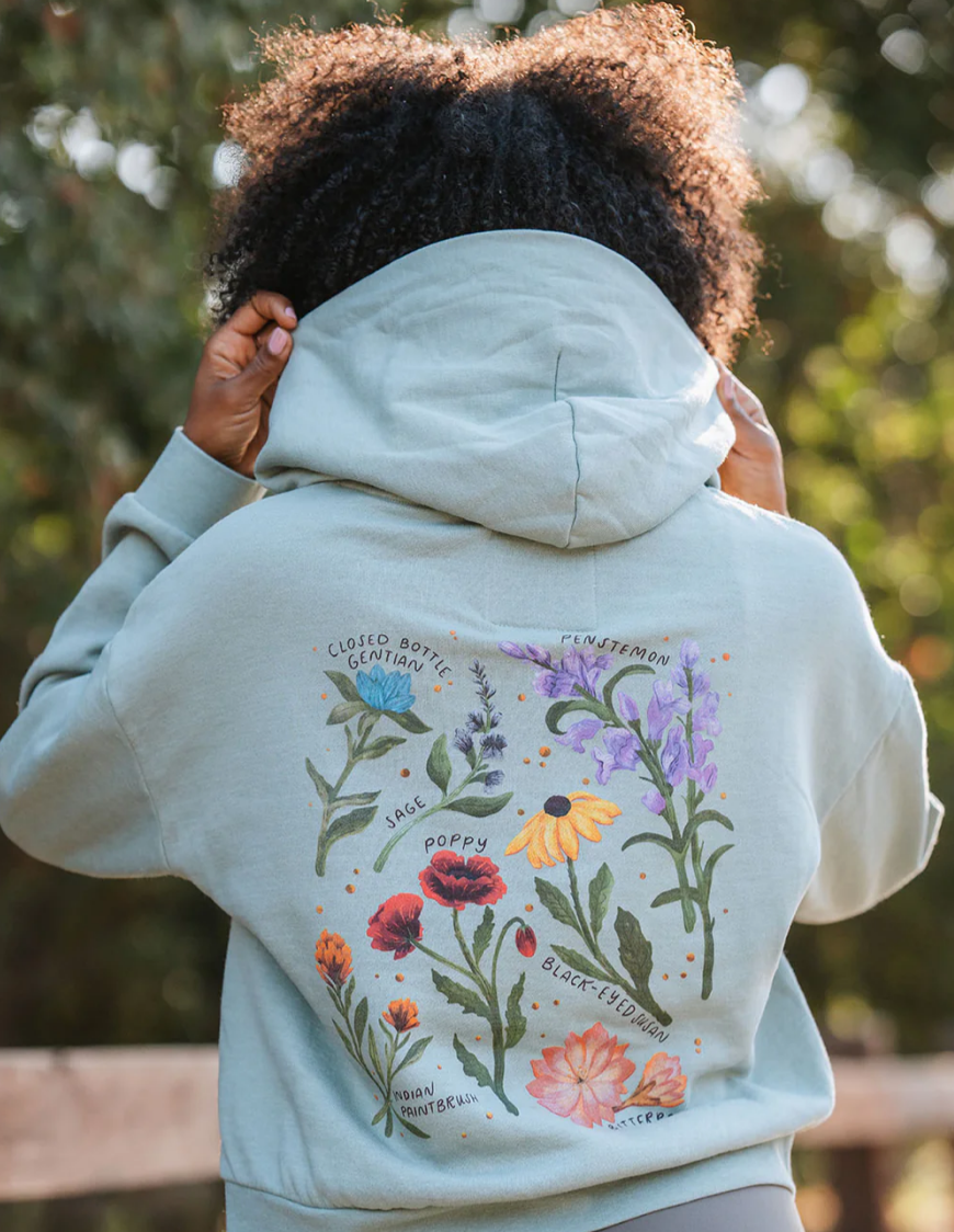 a greeting card with a painting of flowers and leaves on it .