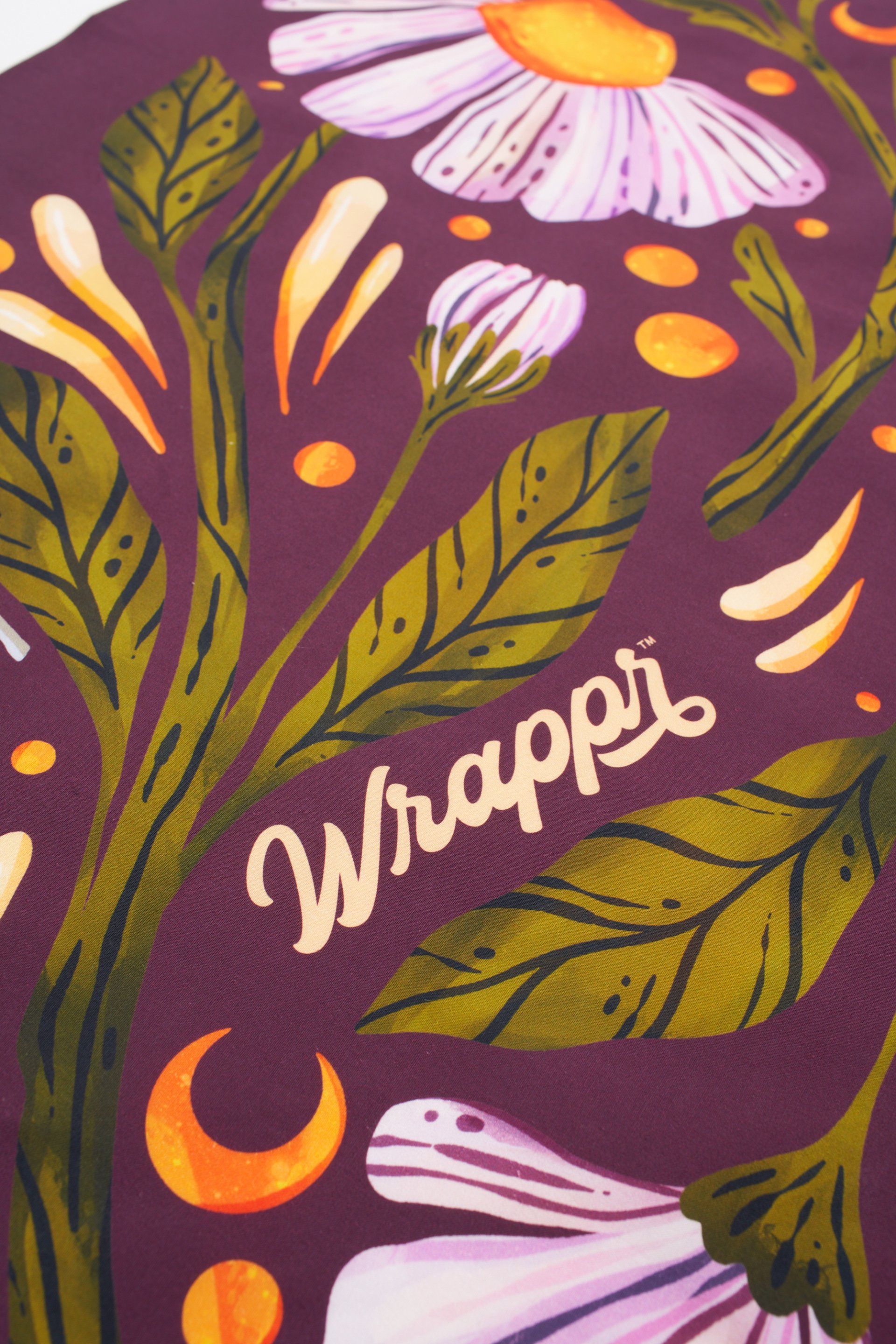 a purple background with flowers and leaves and the word wrappi on it