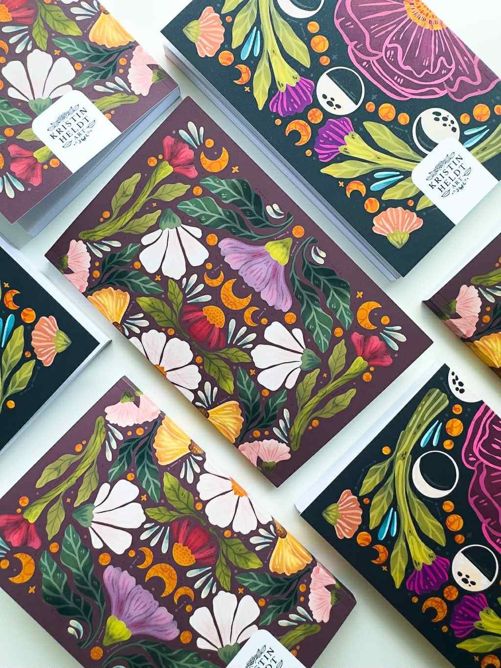 a pair of notebooks with a floral pattern on them