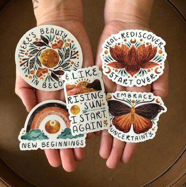 a person is holding stickers that say there 's beauty in becoming like rising sun i start again and new beginnings