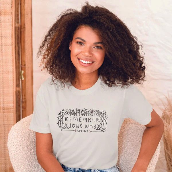 a woman wearing a white t-shirt that says remember your why