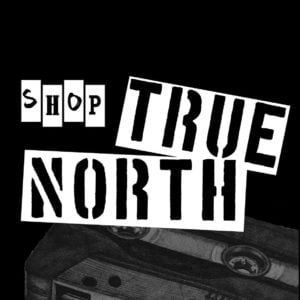 A black and white sign that says shop true north