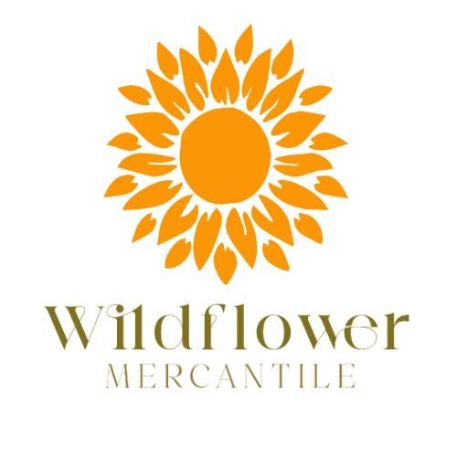 A logo for wildflower mercantile with a sunflower in the center