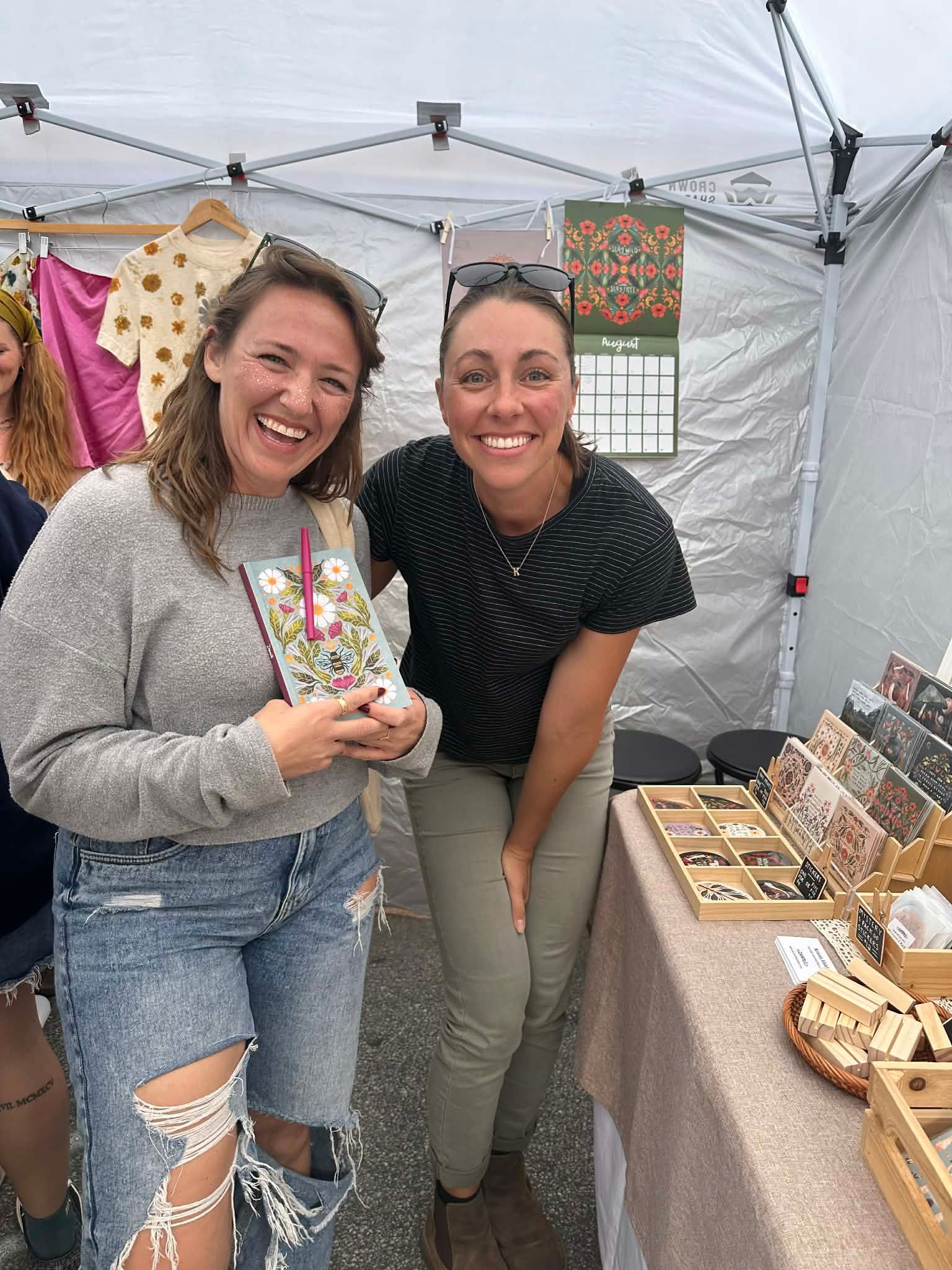 a woman with long hair is sitting in a chair and smiling .
